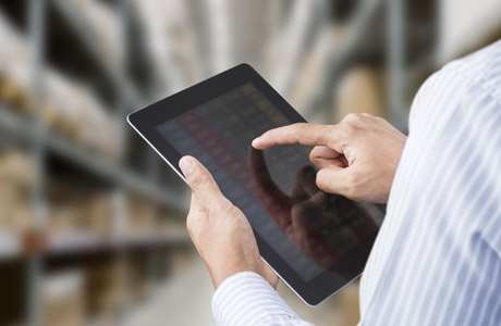 Fingers of a man scrolling through a tablet