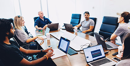 People having a meeting in a large room