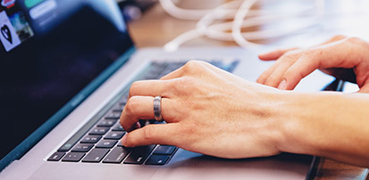 Hands on a laptop keyboard